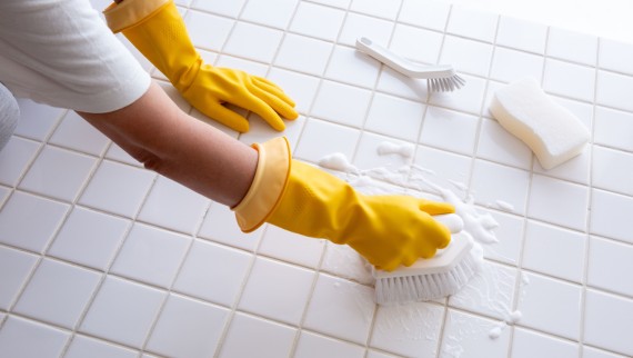 Woman scrubbing bathroom floor Woman scrubbing bathroom floor